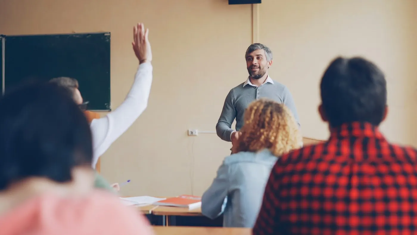 A teacher asking a question in a classroom