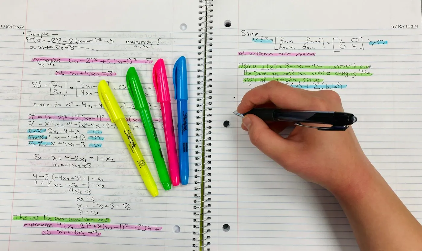 Handwritten study notes and a highlighter on a desk