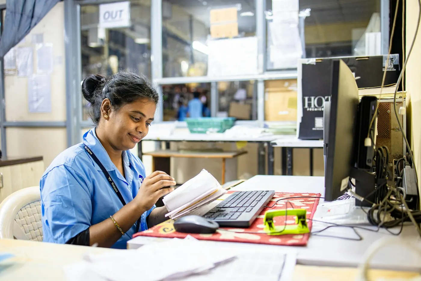 A nursing student smiling while studying at a computer