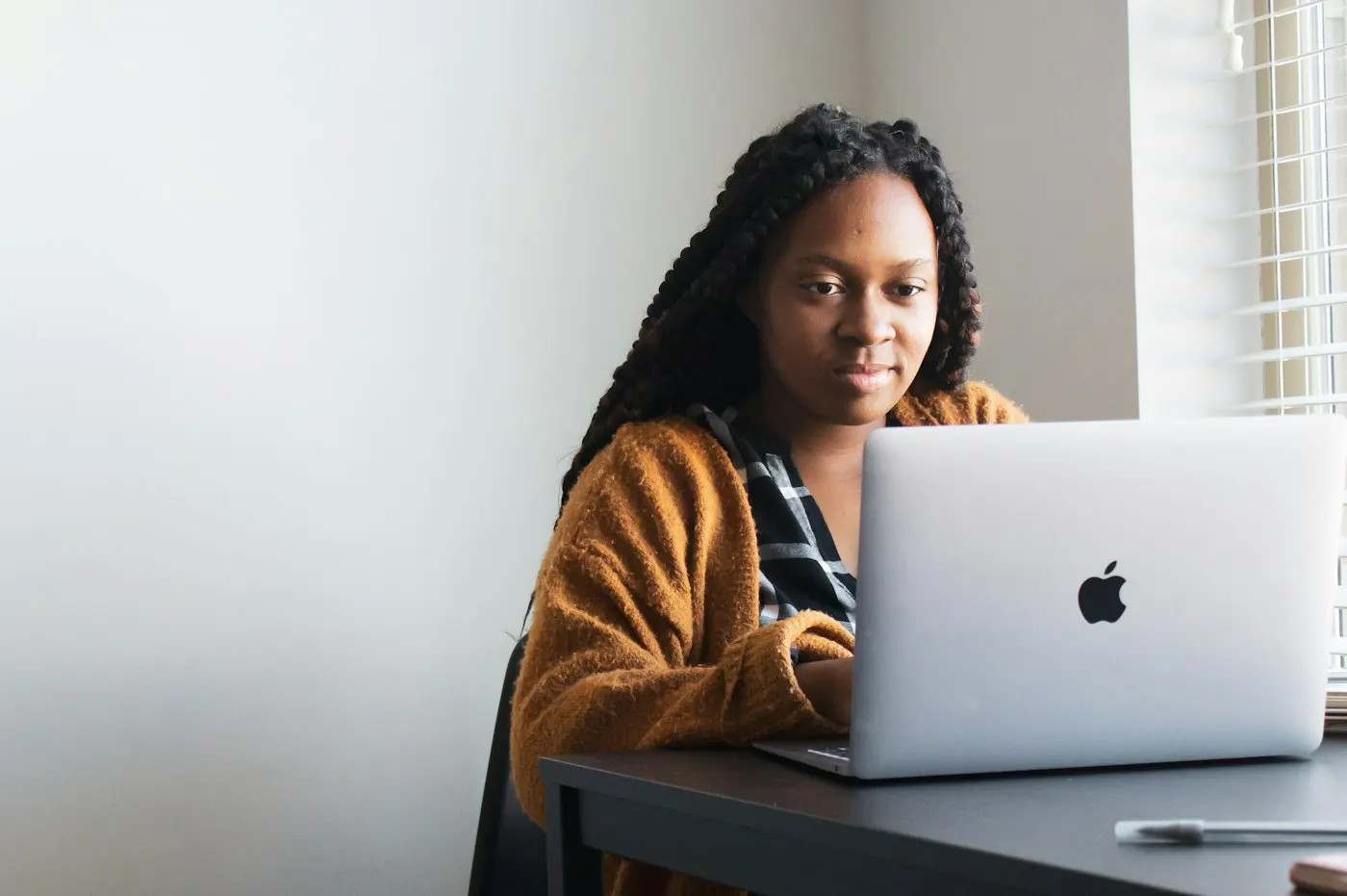 A student working on a laptop at a desk